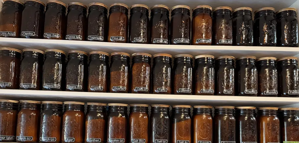 Amber jars of grains, spices, and pantry ingredients